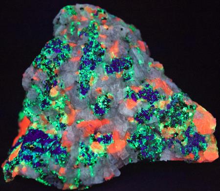 Fluorescent barite, calcite, willemite, hardystonite under shortwave UV light Fluorescent barite, calcite, willemite, hardystonite under shortwave UV light