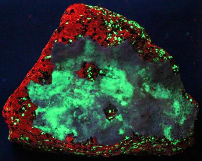 Aragonite coating on calcite / willemite / franklinite ore, Buckwheat Dump Franklin under shortwave UV Light