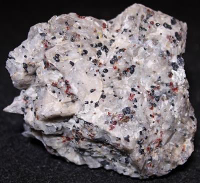 Dark Pink Fluorescent Calcite, willemite, franklinite and zincite, Trotter Dump, Franklin NJ.