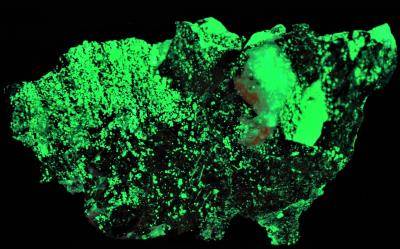 Copper, willemite, franklinite and minor calcite from Franklin, NJ. under shortwave UV Light