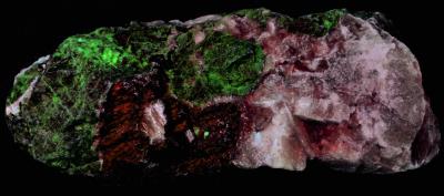 Fluorapatite, grape willemite, calcite and franklinite from Franklin, NJ under longwave UV Light