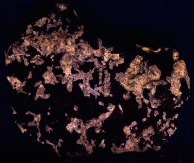 Fluorapatite, pyroxene, willemite and calcite from Taylor Road Dump, Franklin, NJ under midwave UV Light