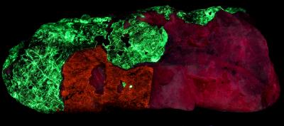 Fluorapatite, grape willemite, calcite and franklinite from Franklin, NJ under shortwave UV Light