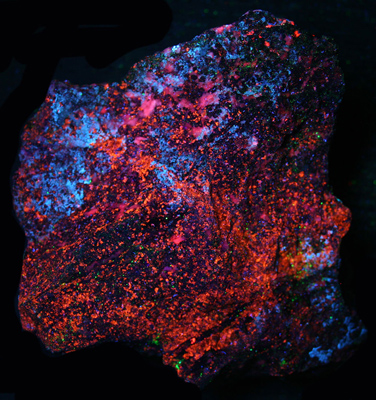 Weathered sphalerite, calcite, and hydrozincite under longwave UV Light