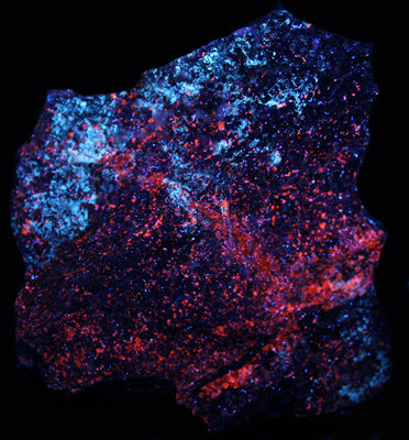 Weathered sphalerite, calcite, and hydrozincite under shortwave UV Light