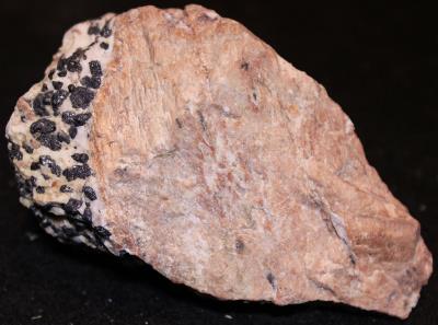 Pink willemite with calcite and franklinite, from the Sterling Hill Mine NJ.