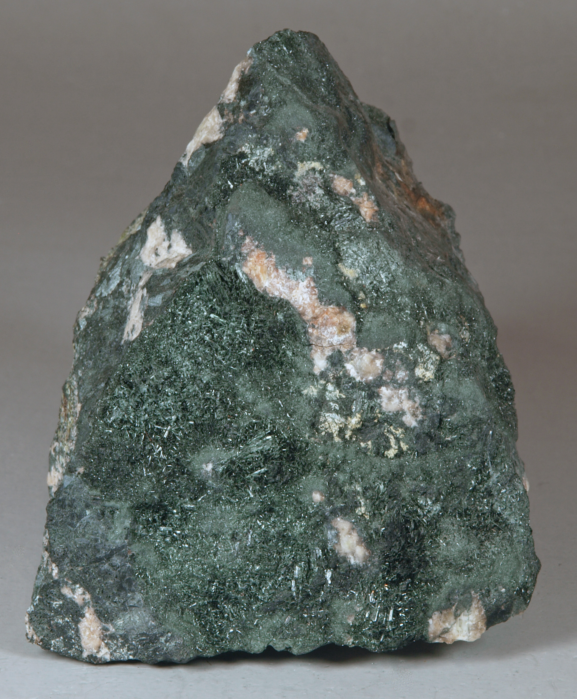 Fairly fine-grained pyroxene-feldspar gneiss in contact with recrystallized masses of medium-grained, dark green actinolite