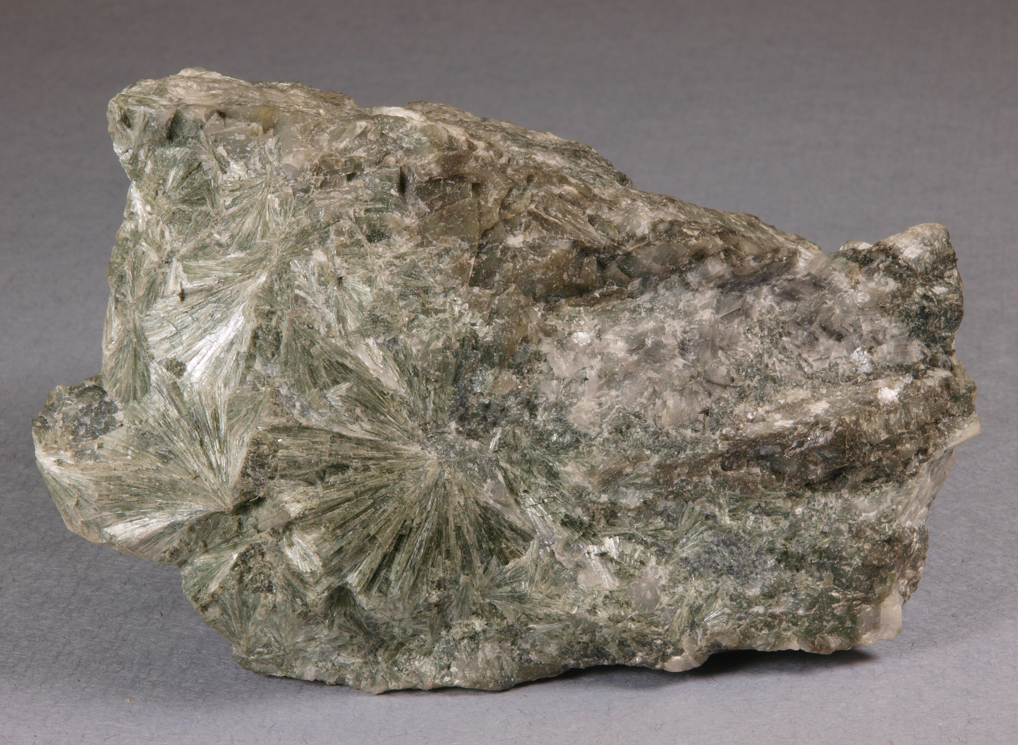 Intergrown radiating masses of pale green, fibrous actinolite with pale gray calcite