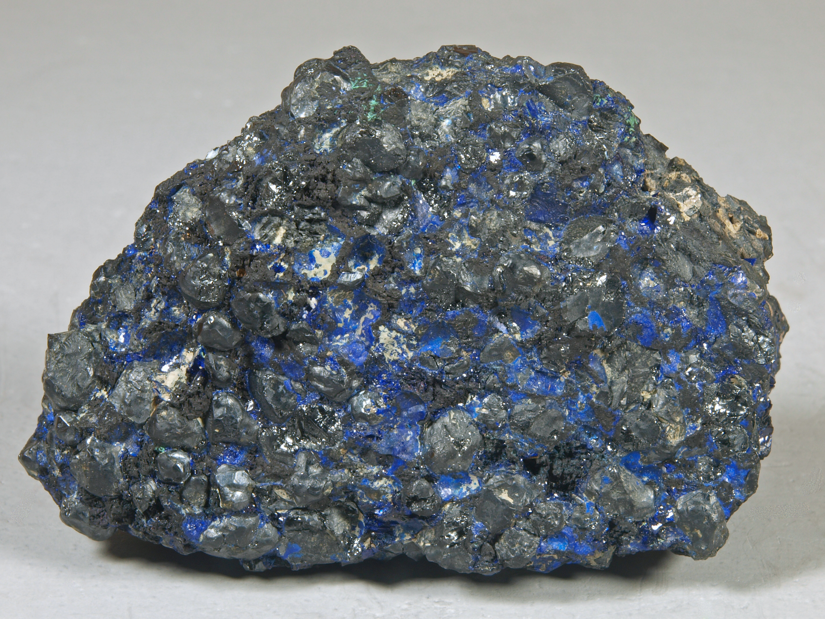 Films and small masses of deep blue azurite in a granular aggregate of residual franklinite