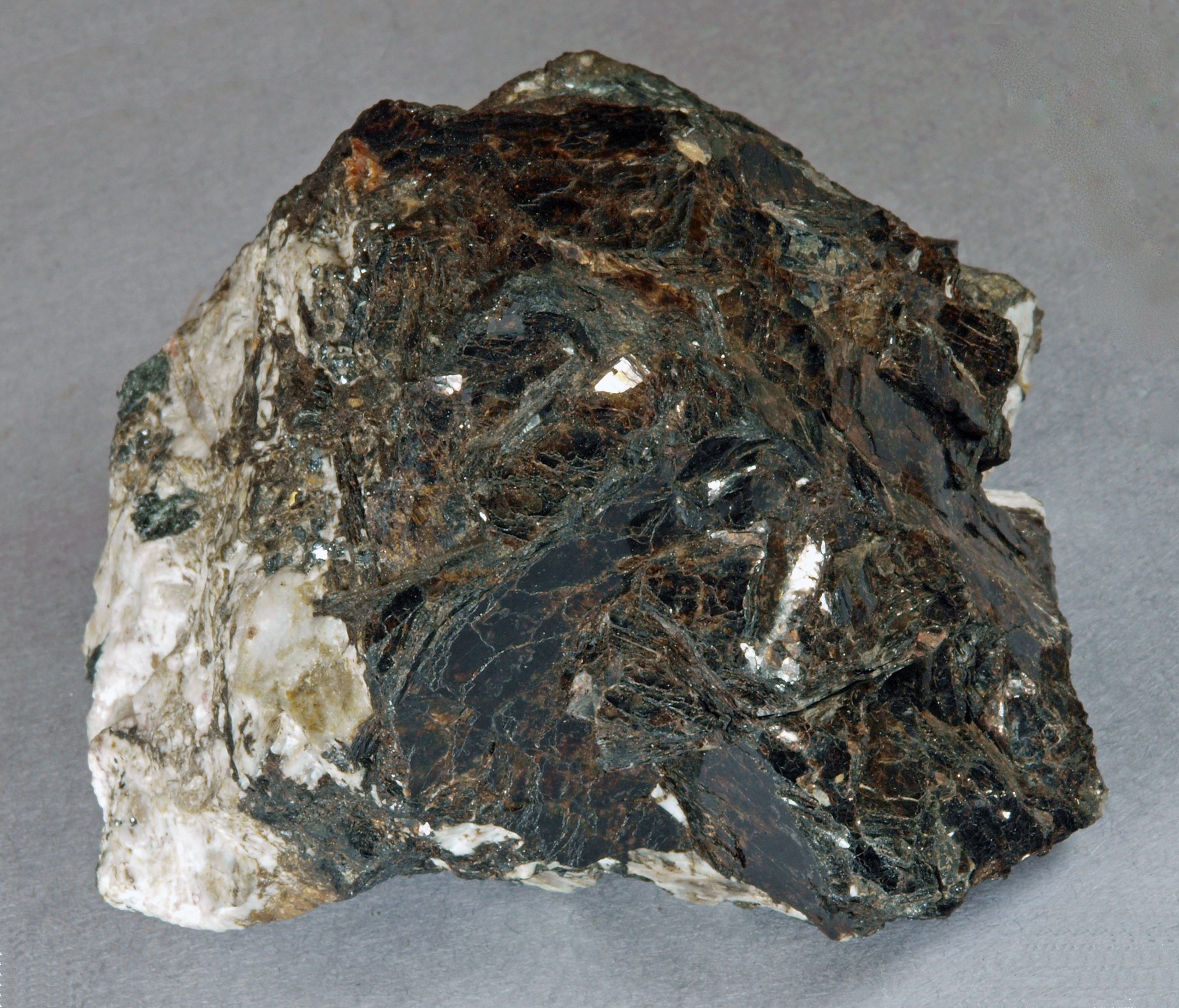 Bannisterite in broad, intergrown, tabular, dark brown crystals of micaceous habit