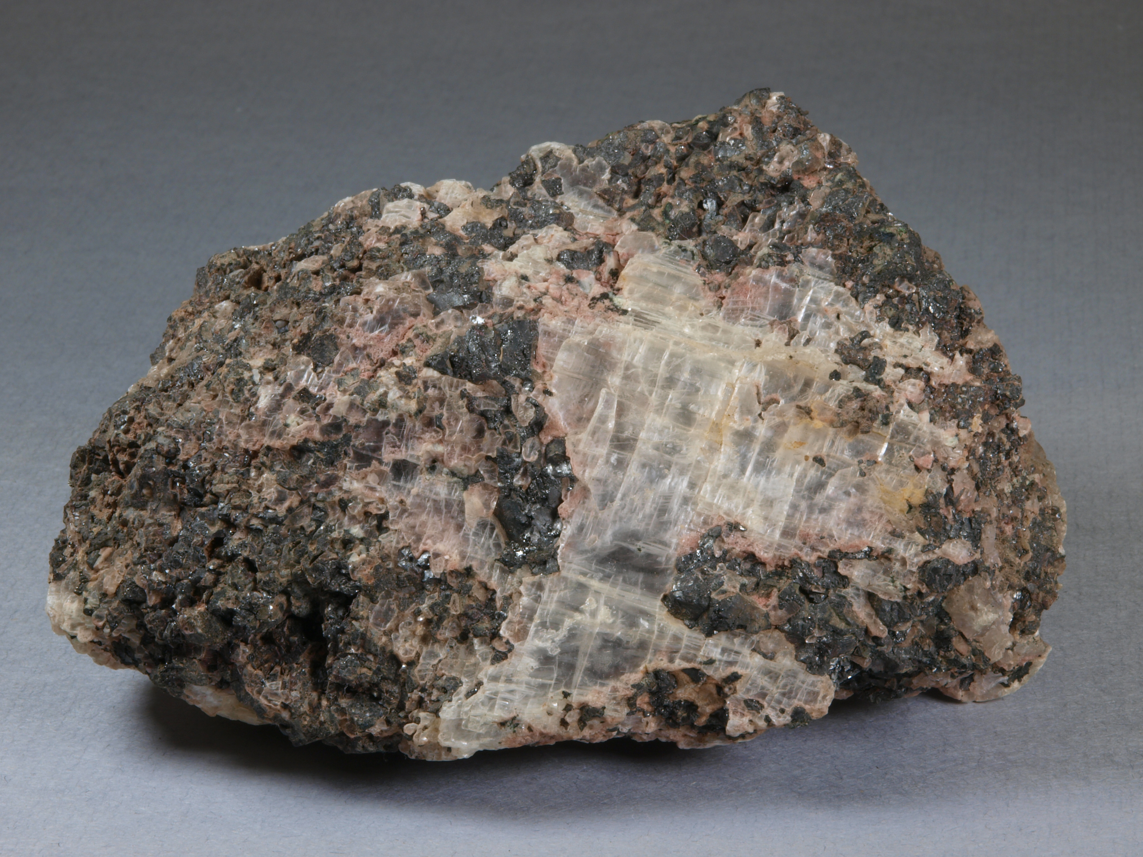 Coarse-grained, transparent, colorless gypsum in vuggy, thoroughly leached, franklinite-calcite ore