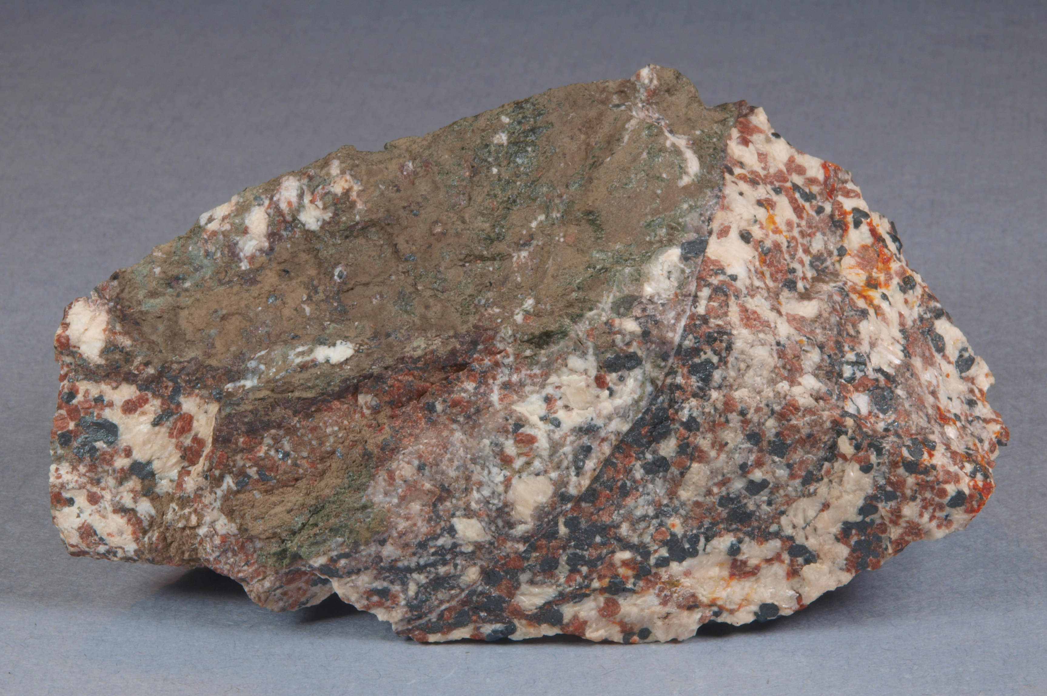 Dark olive-green to brown magnussonite, slightly brecciated, granular willemite-franklinite-calcite ore