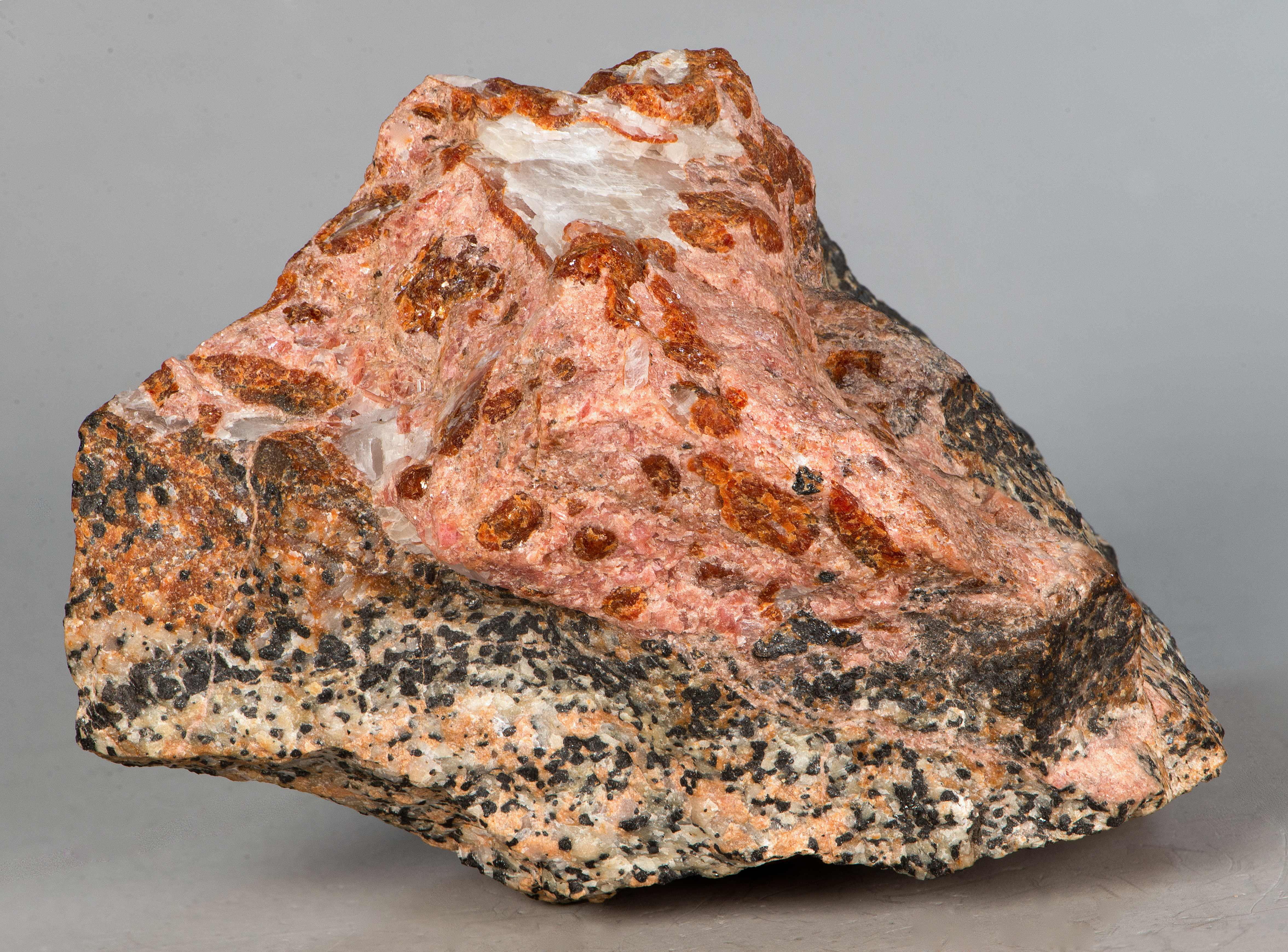 SCH4, brown schallerite, rhodonite, white barite, white calcite on franklinite-willemite-calcite ore, Franklin mine, Franklin NJ