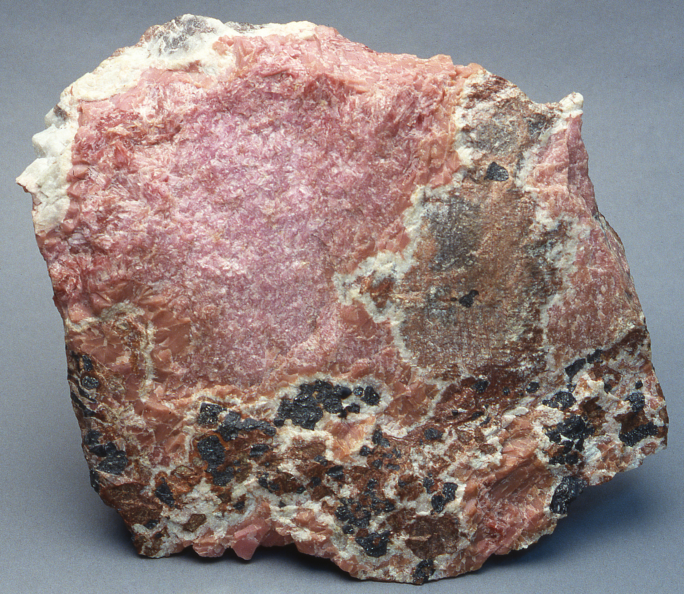 Deep pink to brownish-pink sussexite, franklinite, calcite, willemite, serpentine, Sterling mine, Ogdensburg
