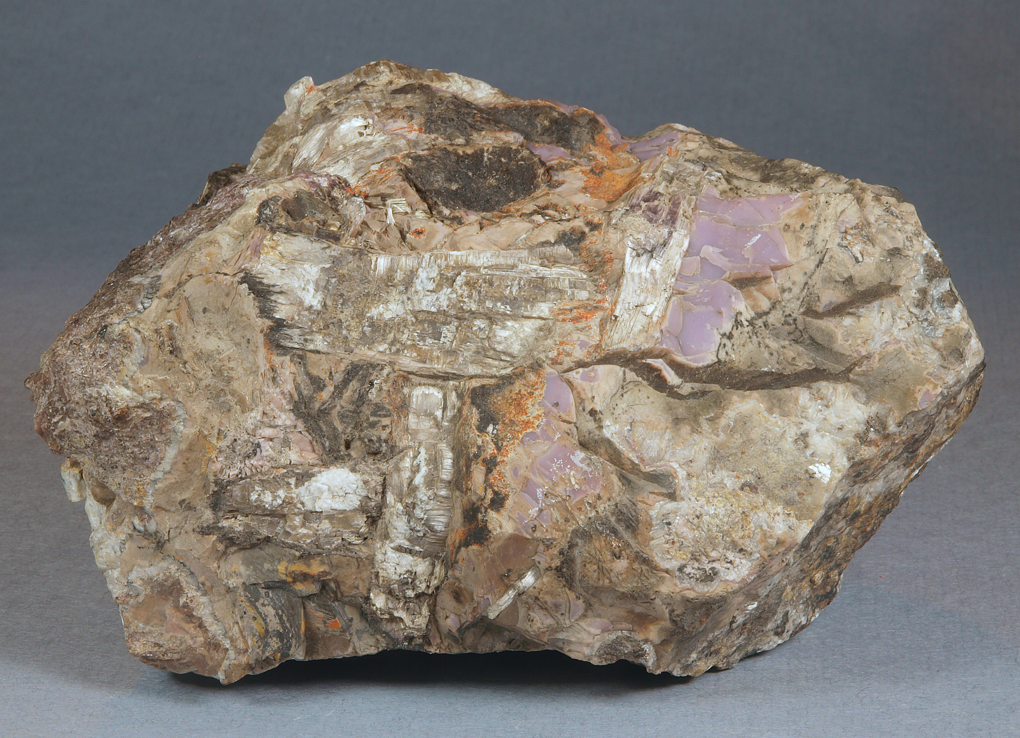 Pinkish-lavender cherty sussexite, tan fibrous sussexite, zincite, Sterling mine, Ogdensburg